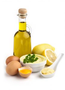 bowl of mayonnaise and ingredients on white background